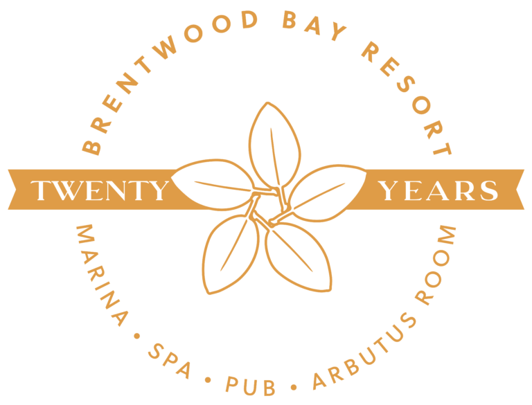 Logo for Brentwood Bay Resort's 20th anniversary features a central leaf design. The text "Twenty Years" is overlaid on a ribbon with surrounding words "Marina," "Spa," "Pub," and "Arbutus Room" to highlight the resort's diverse offerings.